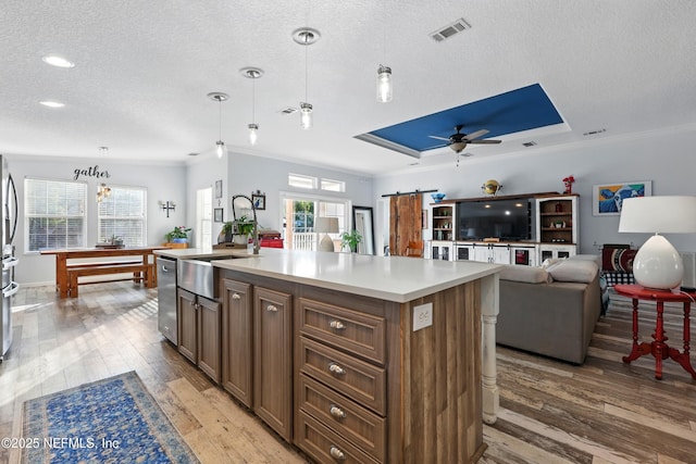 1417 Marlee Rd, Saint Johns, FL 32259 - kitchen featuring a textured ceiling, crown molding, light wood-style flooring, light countertops, and dishwasher