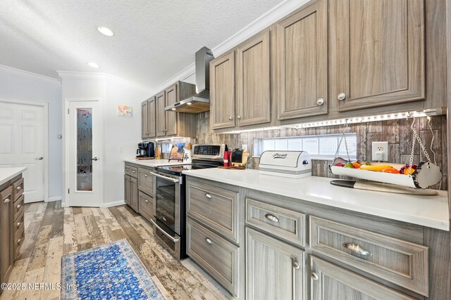 1417 Marlee Rd, Saint Johns, FL 32259 - kitchen featuring electric stove, wall chimney range hood, crown molding, light wood-style floors, and light countertops