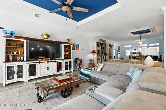 1417 Marlee Rd, Saint Johns, FL 32259 - living area with a ceiling fan, wood finished floors, crown molding, a tray ceiling, and baseboards