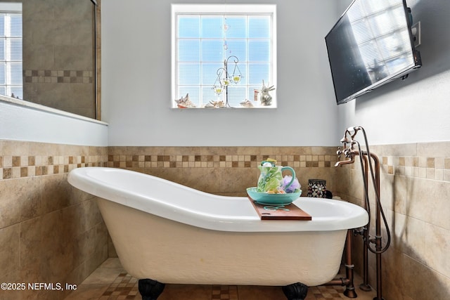 1417 Marlee Rd, Saint Johns, FL 32259 - bathroom featuring tile walls, a wainscoted wall, a soaking tub, and tile patterned flooring