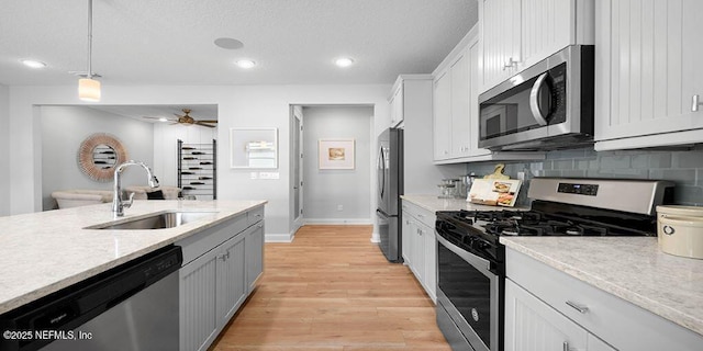 166 Whistling Straits Dr, Saint Johns, FL 32259 - kitchen with recessed lighting, stainless steel appliances, a sink, light wood-type flooring, and pendant lighting
