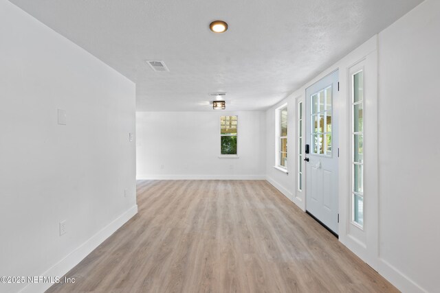 360 Varella Ave, Saint Augustine, FL 32084 - foyer entrance with baseboards and light wood-type flooring