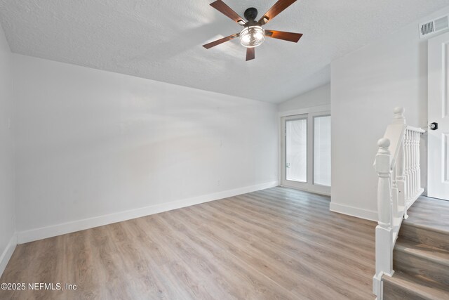 360 Varella Ave, Saint Augustine, FL 32084 - unfurnished room with lofted ceiling, a textured ceiling, baseboards, light wood finished floors, and ceiling fan