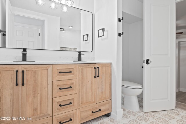 360 Varella Ave, Saint Augustine, FL 32084 - full bathroom featuring double vanity, toilet, and baseboards