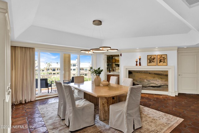 948 Spinnakers Reach Dr, Ponte Vedra Beach, FL 32082 - dining area with a tray ceiling, a chandelier, and a fireplace