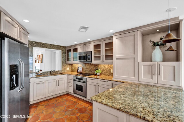 948 Spinnakers Reach Dr, Ponte Vedra Beach, FL 32082 - kitchen featuring appliances with stainless steel finishes, glass insert cabinets, a sink, dark tile patterned flooring, and tasteful backsplash