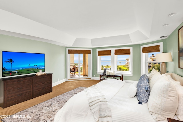 948 Spinnakers Reach Dr, Ponte Vedra Beach, FL 32082 - bedroom with a raised ceiling, multiple windows, and carpet flooring