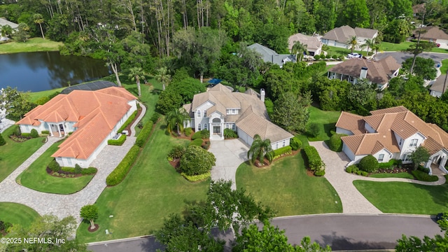 drone / aerial view with a water view and a residential view