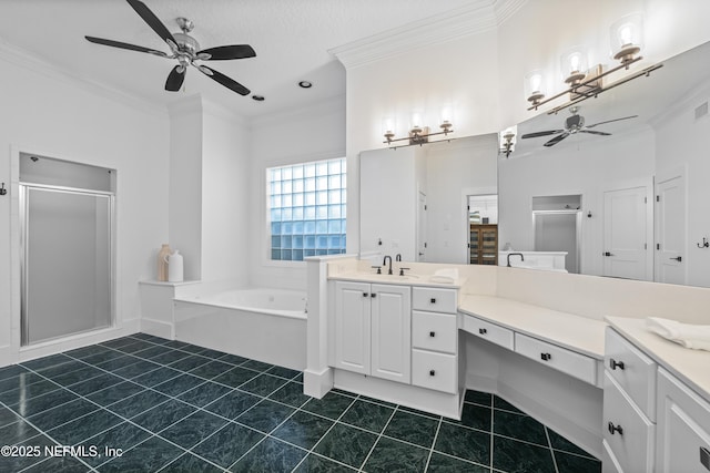bathroom with crown molding, vanity, a ceiling fan, a garden tub, and a stall shower
