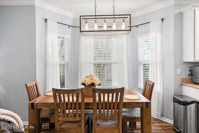 dining space with baseboards, ornamental molding, a chandelier, and dark wood-style floors