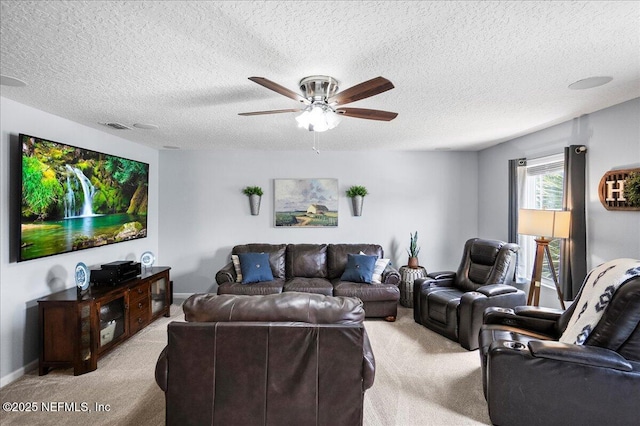 living room with a ceiling fan, a textured ceiling, visible vents, and light colored carpet