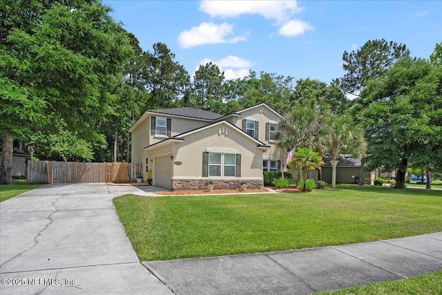 view of front facade with driveway, a front yard, fence, stucco siding, and stone siding