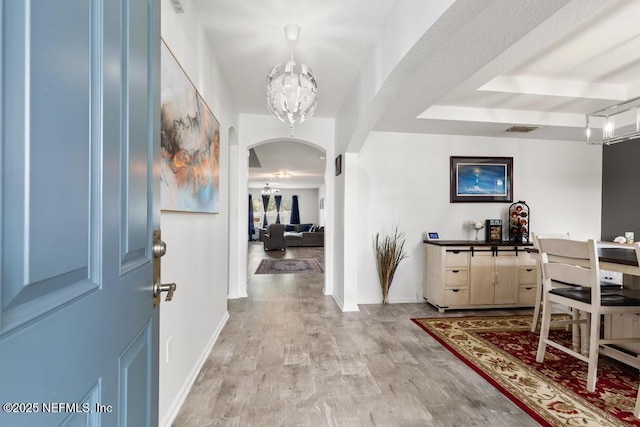3753 Old Hickory Ln, Orange Park, FL 32065 - entryway featuring an inviting chandelier, arched walkways, baseboards, and light wood-type flooring