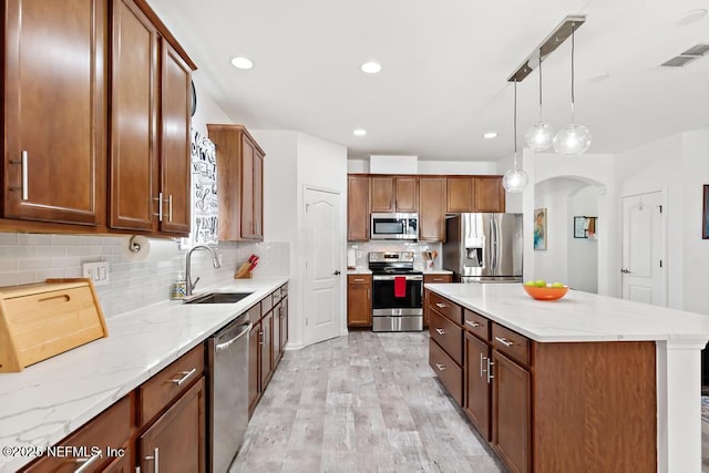 3753 Old Hickory Ln, Orange Park, FL 32065 - kitchen featuring visible vents, light wood-type flooring, arched walkways, a sink, and stainless steel appliances