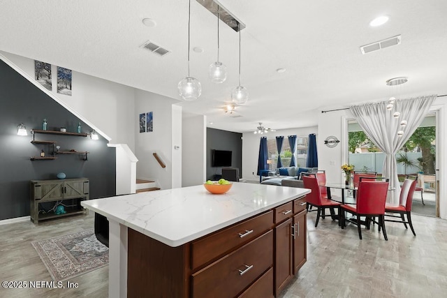 3753 Old Hickory Ln, Orange Park, FL 32065 - kitchen featuring light wood-style floors, a center island, decorative light fixtures, and visible vents