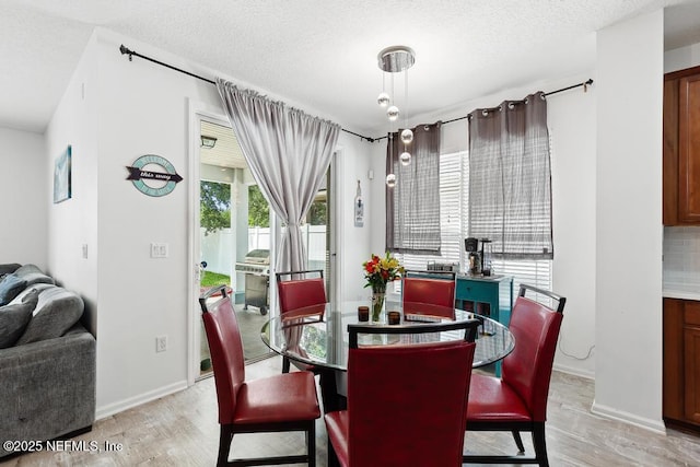 3753 Old Hickory Ln, Orange Park, FL 32065 - dining area featuring baseboards, light wood-type flooring, and a textured ceiling