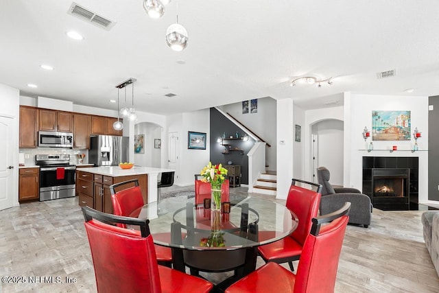 3753 Old Hickory Ln, Orange Park, FL 32065 - dining room with visible vents, arched walkways, and stairs