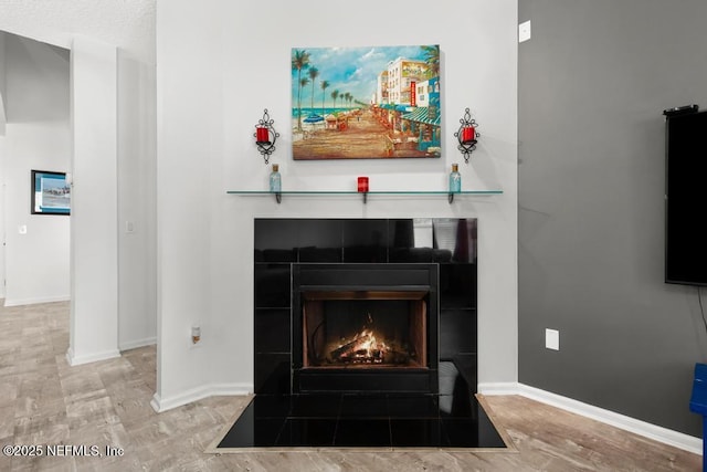 3753 Old Hickory Ln, Orange Park, FL 32065 - room details with baseboards, a tiled fireplace, and wood finished floors