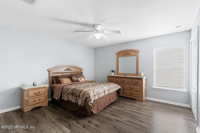3753 Old Hickory Ln, Orange Park, FL 32065 - bedroom with dark wood-style flooring, baseboards, a ceiling fan, and a textured ceiling