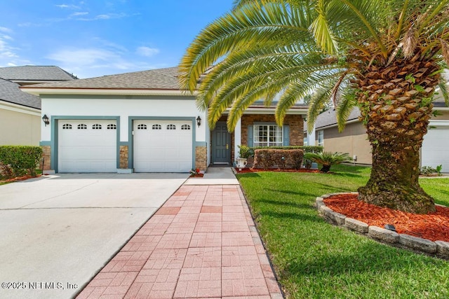 3753 Old Hickory Ln, Orange Park, FL 32065 - view of front of house with a front yard, roof with shingles, stucco siding, an attached garage, and driveway