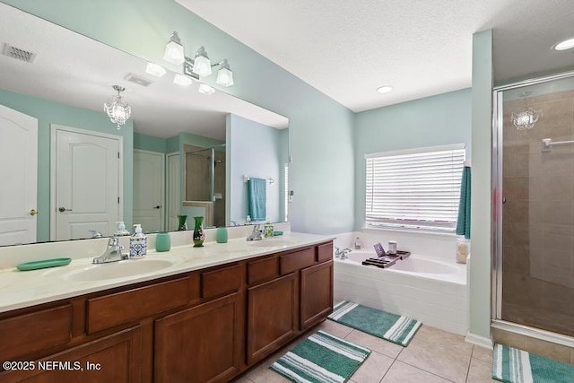 3753 Old Hickory Ln, Orange Park, FL 32065 - bathroom with a sink, double vanity, visible vents, a garden tub, and a stall shower