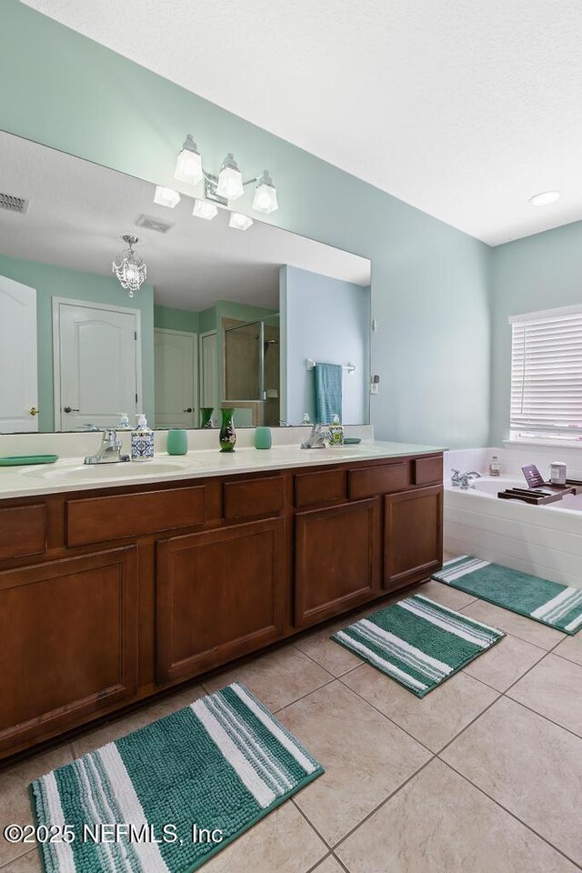 3753 Old Hickory Ln, Orange Park, FL 32065 - bathroom featuring tile patterned flooring, vanity, a shower with door, visible vents, and a garden tub