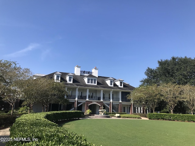 3753 Old Hickory Ln, Orange Park, FL 32065 - view of front facade with a balcony, a front yard, and a chimney