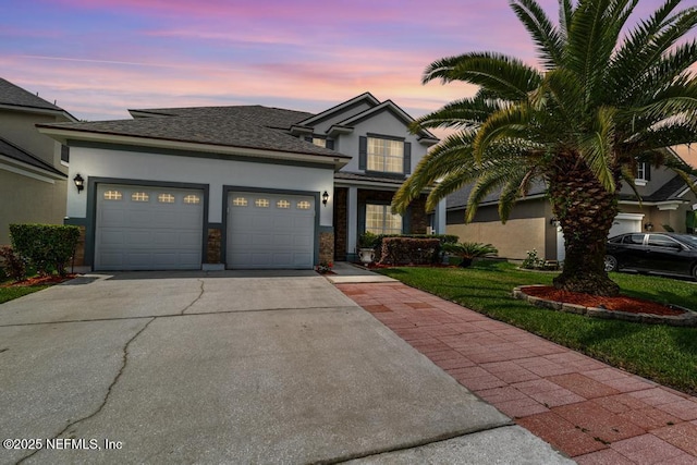 3753 Old Hickory Ln, Orange Park, FL 32065 - traditional-style home featuring a garage, stucco siding, and driveway