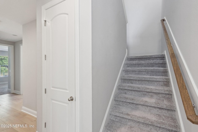stairs featuring baseboards and wood finished floors