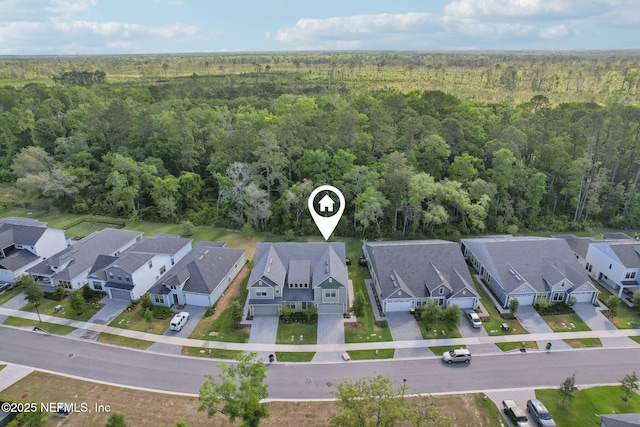 birds eye view of property with a residential view and a view of trees