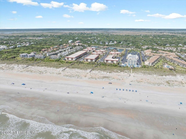 birds eye view of property featuring a beach view and a water view