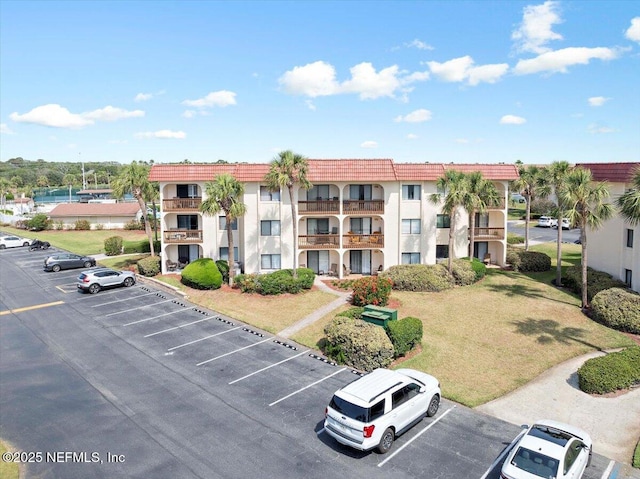 view of building exterior featuring uncovered parking