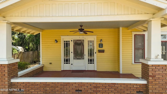703 Emmett St, Palatka, FL 32177 - view of exterior entry featuring fence and ceiling fan