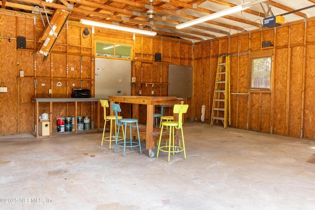 703 Emmett St, Palatka, FL 32177 - garage featuring a garage door opener and a workshop area