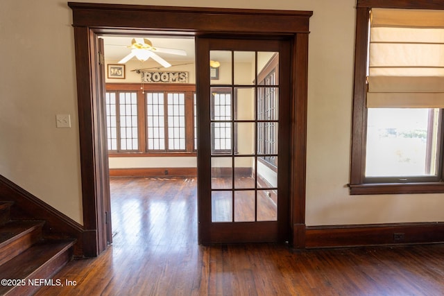 703 Emmett St, Palatka, FL 32177 - doorway featuring stairs, ceiling fan, dark wood-style flooring, and baseboards