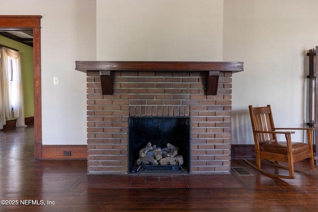 703 Emmett St, Palatka, FL 32177 - details with a fireplace, wood finished floors, visible vents, and baseboards