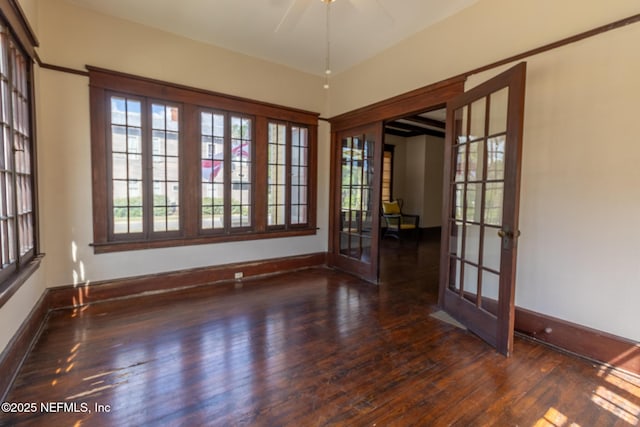 703 Emmett St, Palatka, FL 32177 - spare room with baseboards, wood finished floors, a ceiling fan, and french doors