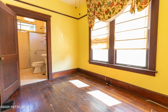 703 Emmett St, Palatka, FL 32177 - spare room with baseboards, visible vents, and wood-type flooring