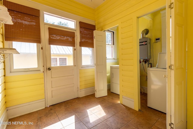 703 Emmett St, Palatka, FL 32177 - entryway featuring water heater, washer / dryer, and plenty of natural light