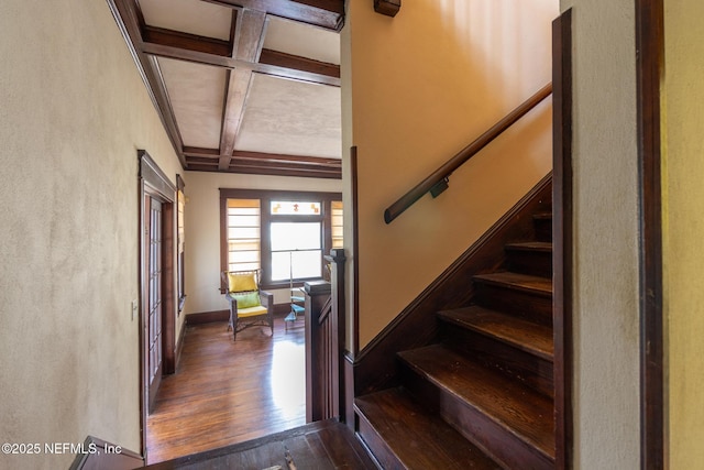 703 Emmett St, Palatka, FL 32177 - staircase featuring coffered ceiling, beam ceiling, wood finished floors, and baseboards