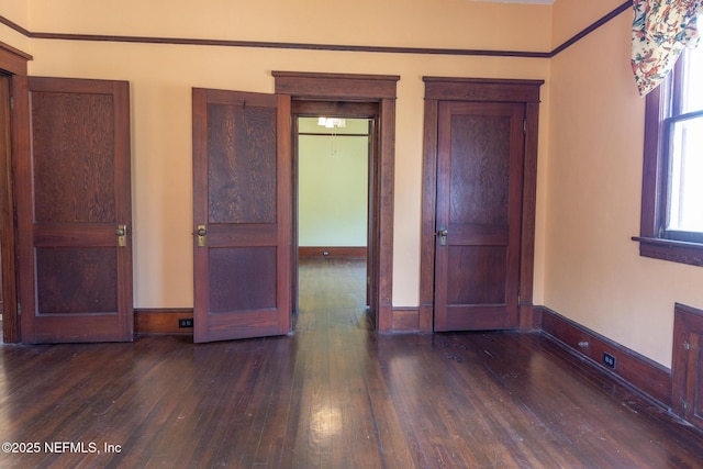 703 Emmett St, Palatka, FL 32177 - unfurnished bedroom featuring hardwood / wood-style floors and baseboards