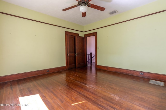 703 Emmett St, Palatka, FL 32177 - spare room featuring visible vents, hardwood / wood-style floors, and baseboards