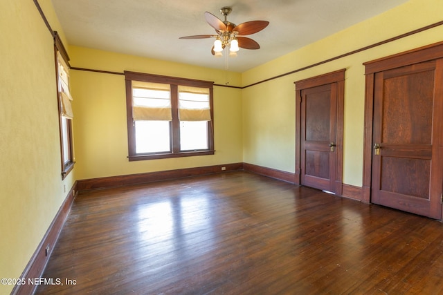 703 Emmett St, Palatka, FL 32177 - spare room featuring dark wood-style floors, ceiling fan, and baseboards