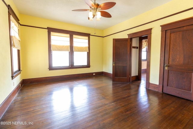 703 Emmett St, Palatka, FL 32177 - unfurnished bedroom with baseboards and dark wood-style flooring