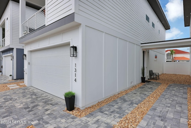 view of side of home featuring board and batten siding and an attached garage