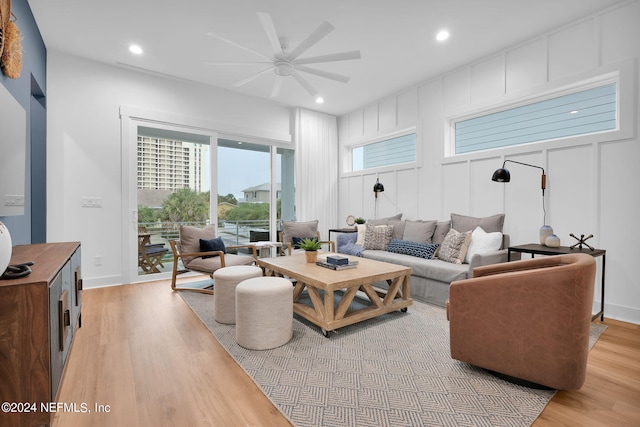 living room featuring ceiling fan, recessed lighting, light wood-style flooring, and baseboards