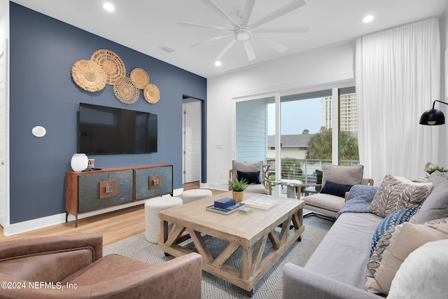 living room featuring baseboards, recessed lighting, wood finished floors, and a ceiling fan