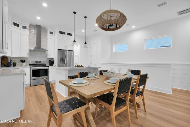dining space featuring visible vents, light wood-type flooring, and recessed lighting
