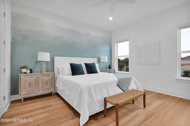 bedroom featuring baseboards, light wood-type flooring, a ceiling fan, and recessed lighting