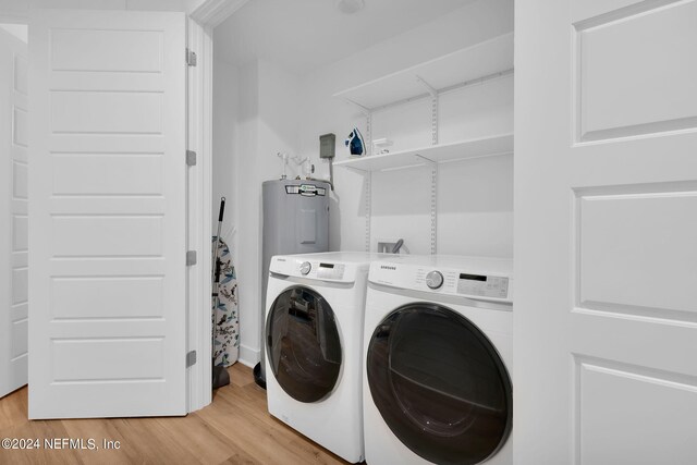 laundry room featuring separate washer and dryer, laundry area, and light wood finished floors